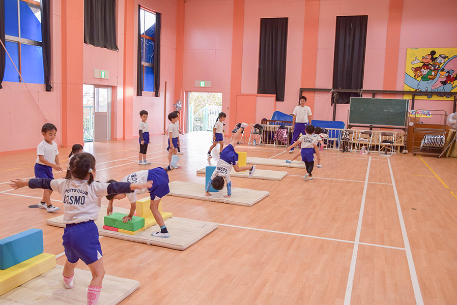 体育館でマット運動をする子どもたちです